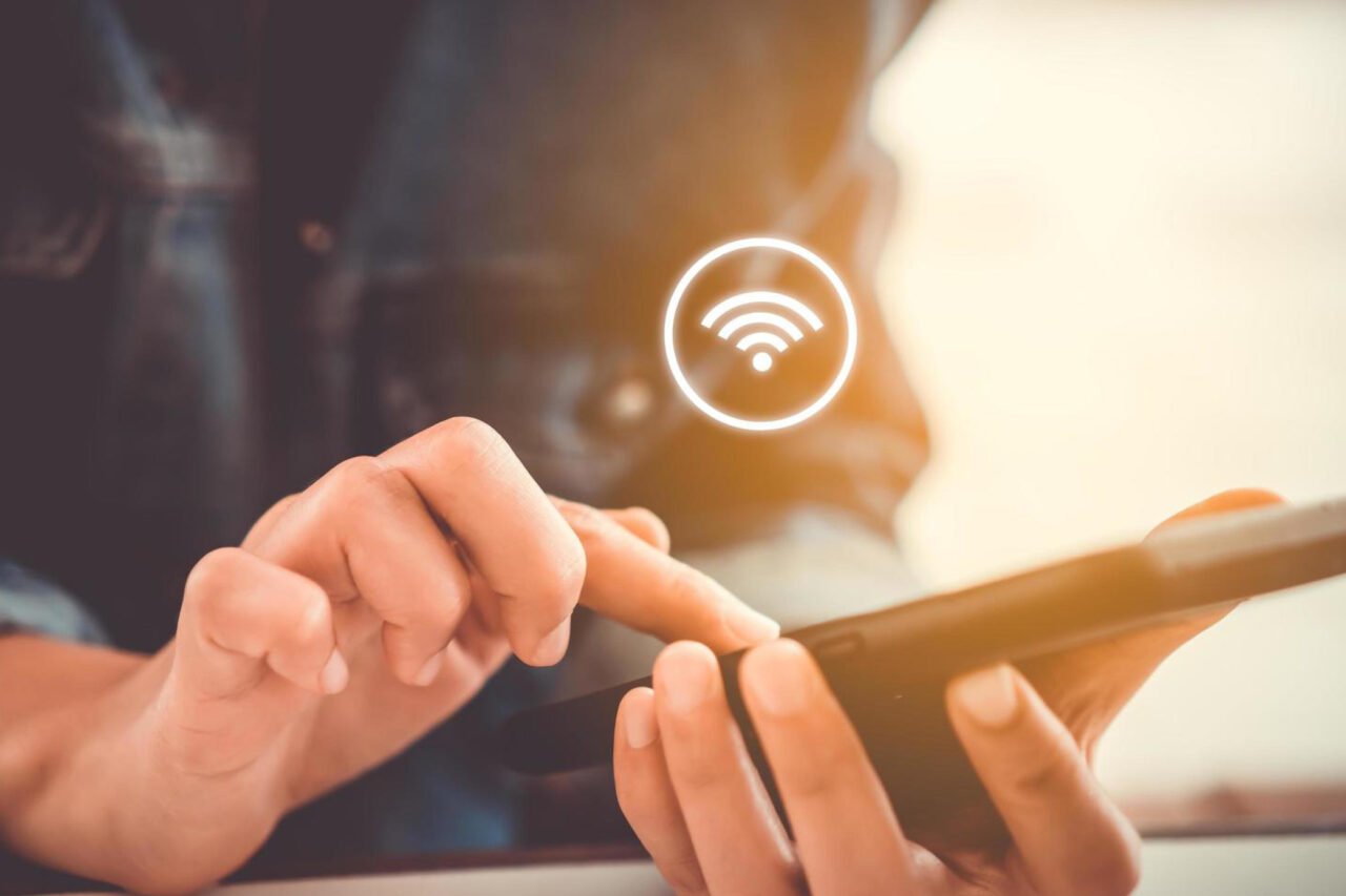 A girl working on cellphone while connected to WIFI