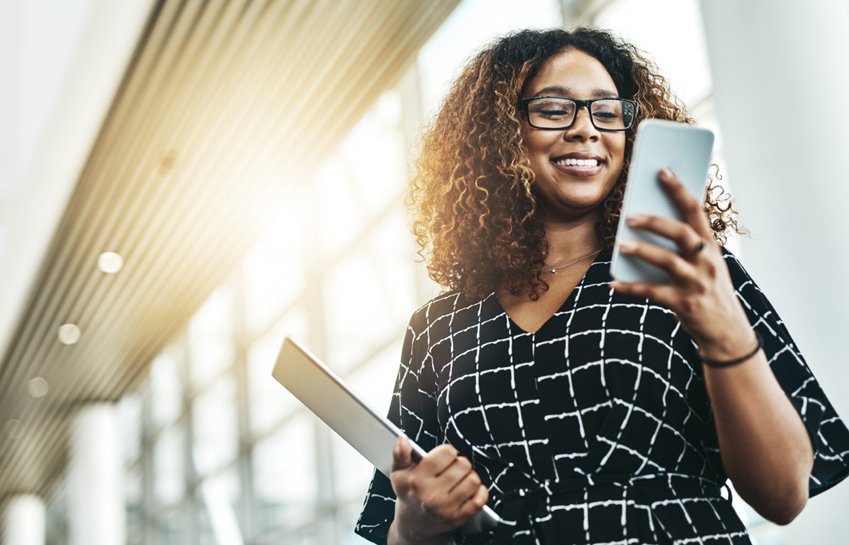 A women smiling while looking at screen