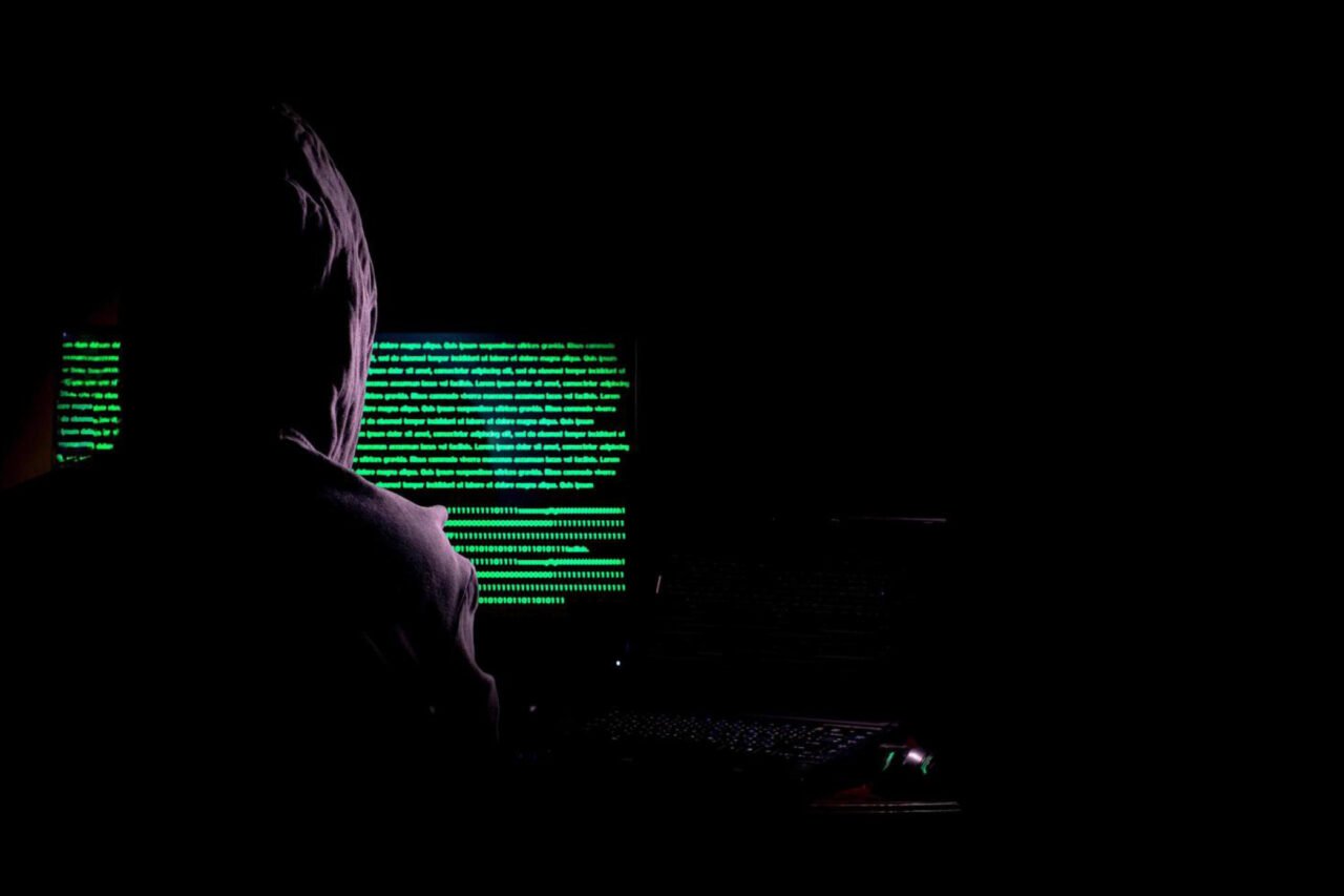 A person sitting in front of computer screen