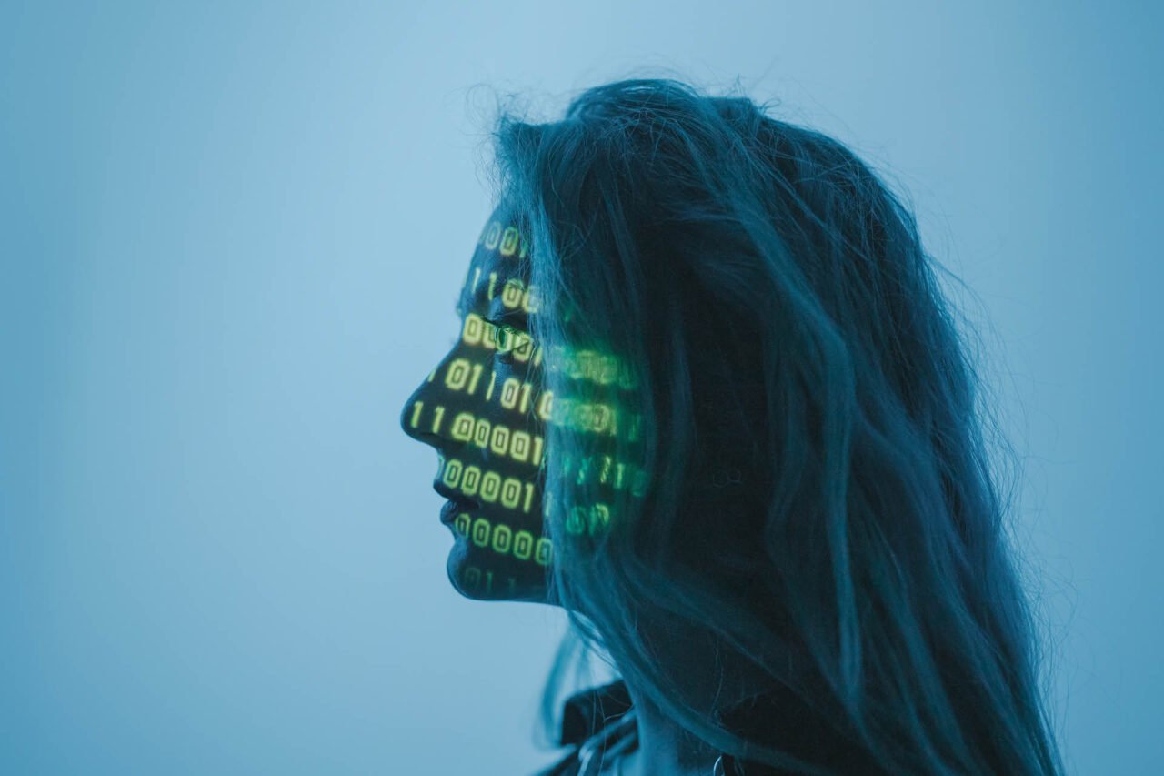 A person standing between projector an screen